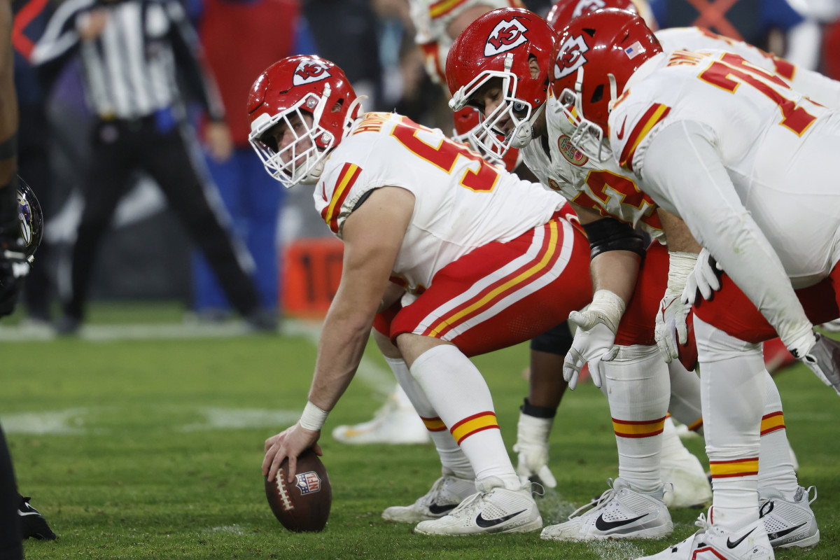 Creed Humphrey bends over to snap the ball
